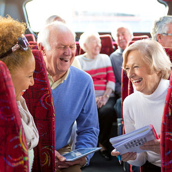 seniors laughing on a bus